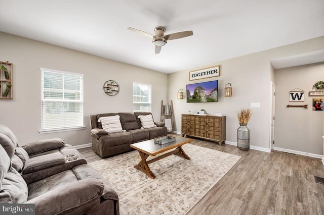 living area featuring ceiling fan, wood finished floors, and baseboards