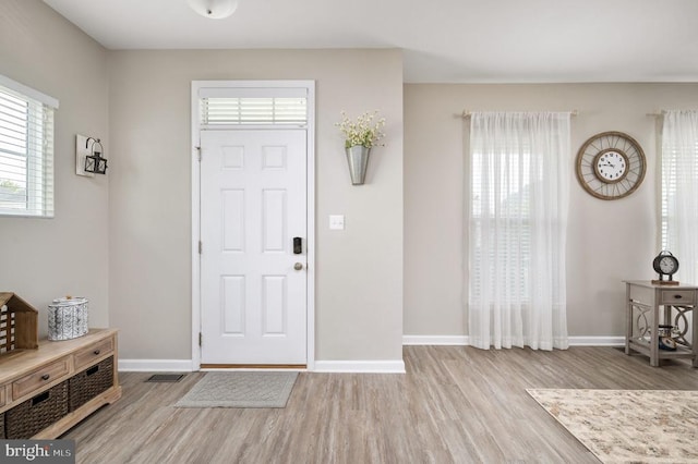 entrance foyer featuring wood finished floors and baseboards