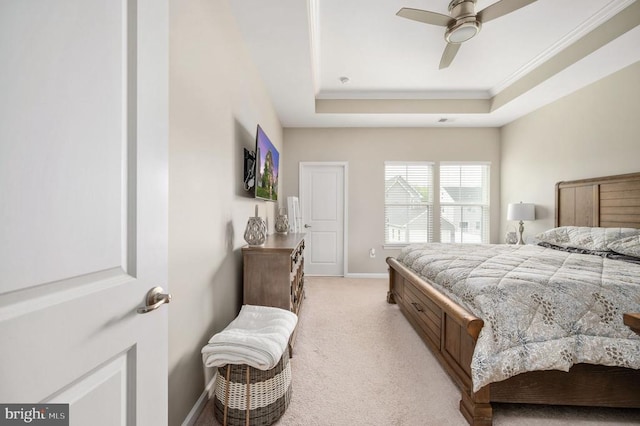 bedroom with light carpet, crown molding, a raised ceiling, baseboards, and ceiling fan