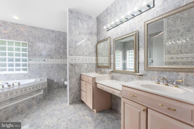 3714 Fairways Ct, Fredericksburg, VA 22408 - bathroom with tile walls, two vanities, a garden tub, tile patterned floors, and a bidet
