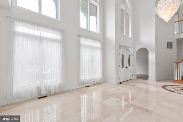 3714 Fairways Ct, Fredericksburg, VA 22408 - foyer featuring a high ceiling, arched walkways, stairway, a chandelier, and marble finish flooring
