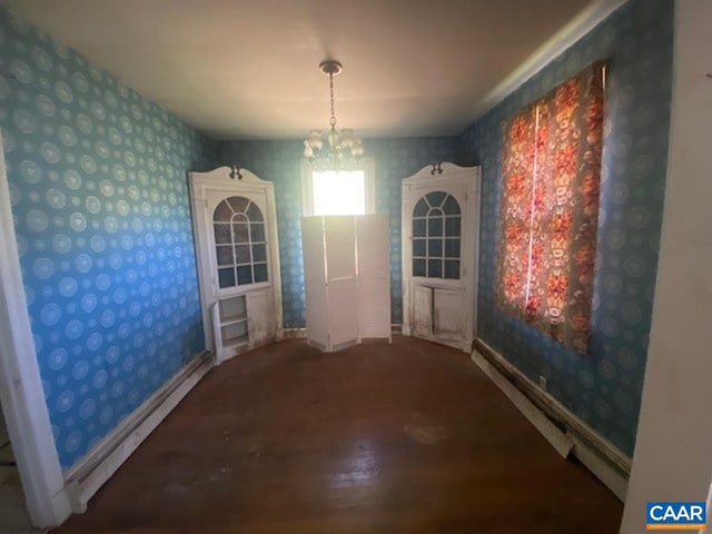 5367 James Madison Hwy, Fork Union, VA 23055 - unfurnished dining area with wallpapered walls, wood finished floors, baseboards, and a chandelier