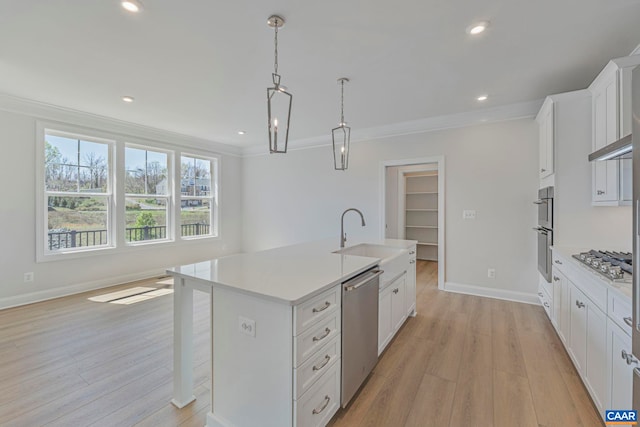 36 Mary Jackson Ct, Charlottesville, VA 22902 - kitchen with appliances with stainless steel finishes, light countertops, ornamental molding, light wood-style floors, and a center island with sink