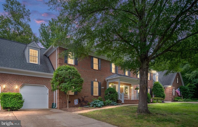 3910 Corbin Hall Ln, Fredericksburg, VA 22408 - view of front of home with brick siding, covered porch, a front lawn, a garage, and concrete driveway