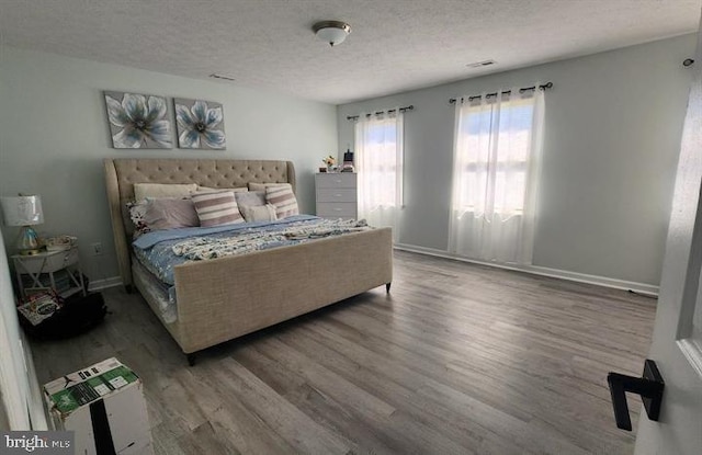 6603 Farmstead Ln, Fredericksburg, VA 22407 - bedroom with a textured ceiling, wood finished floors, and baseboards