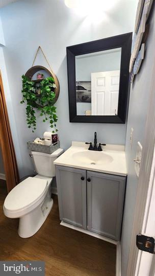 6603 Farmstead Ln, Fredericksburg, VA 22407 - bathroom with vanity, wood finished floors, and toilet