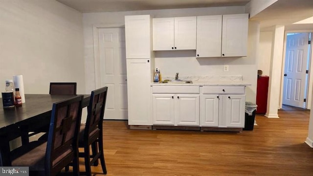 6603 Farmstead Ln, Fredericksburg, VA 22407 - kitchen featuring a sink, wood finished floors, and white cabinets