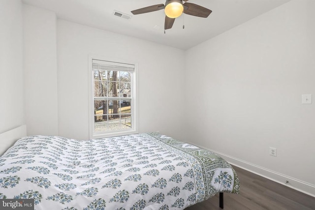 bedroom with dark wood-style floors, baseboards, and ceiling fan
