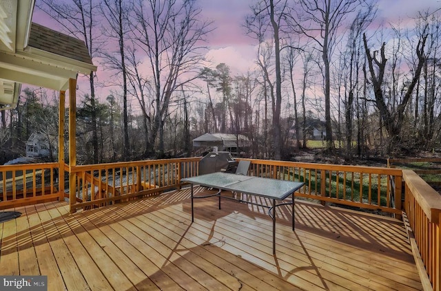 wooden deck featuring view of scattered trees