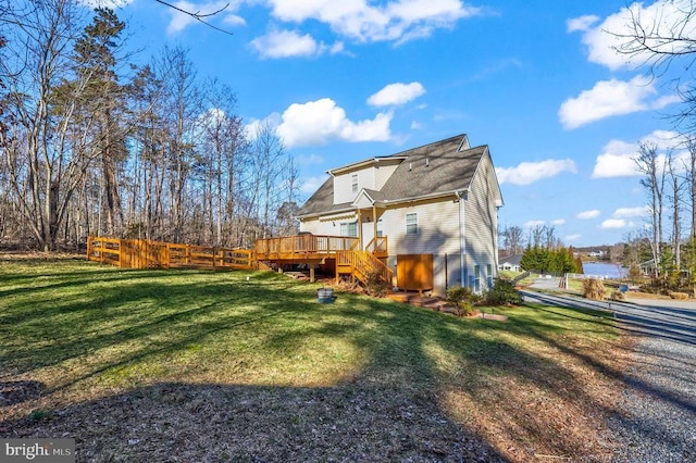 back of property with a wooden deck and stairway