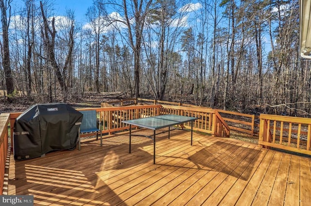wooden deck with a grill