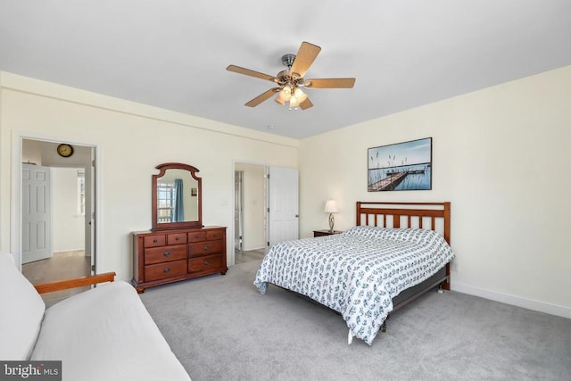 carpeted bedroom with ceiling fan and baseboards