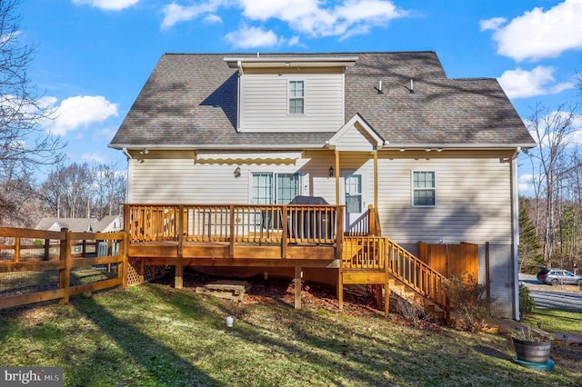 back of house featuring a wooden deck, roof with shingles, and stairs