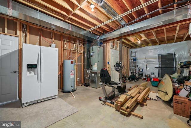 unfinished basement with white fridge with ice dispenser, water heater, and heating unit