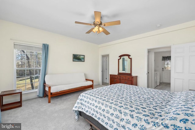 carpeted bedroom with washer / clothes dryer and ceiling fan