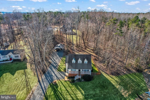 view of subject property with a heavily wooded area