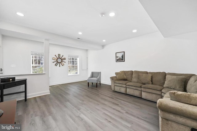 living area with recessed lighting, wood finished floors, and baseboards