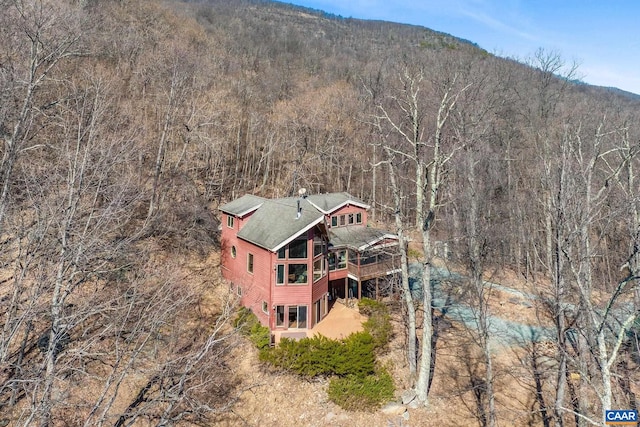 drone / aerial view with a wooded view