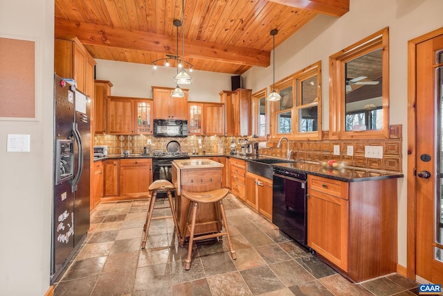 kitchen with glass insert cabinets, a sink, decorative backsplash, black appliances, and beam ceiling