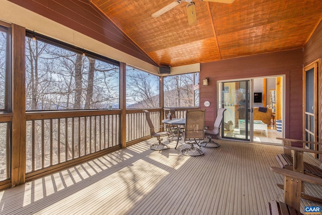 sunroom with a ceiling fan and outdoor dining space