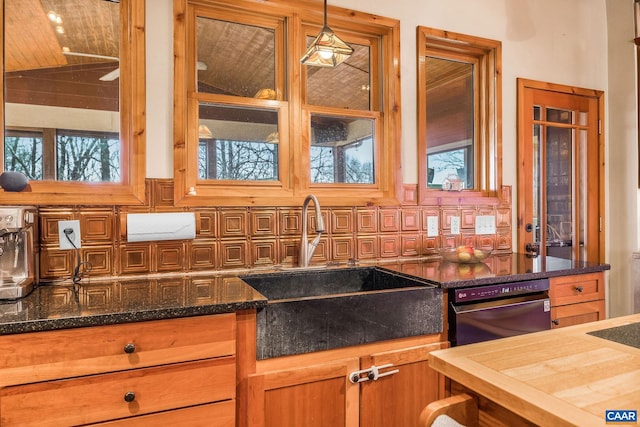 6696 Highlander Way, Crozet, VA 22932 - kitchen with a sink, backsplash, lofted ceiling, pendant lighting, and dark stone countertops