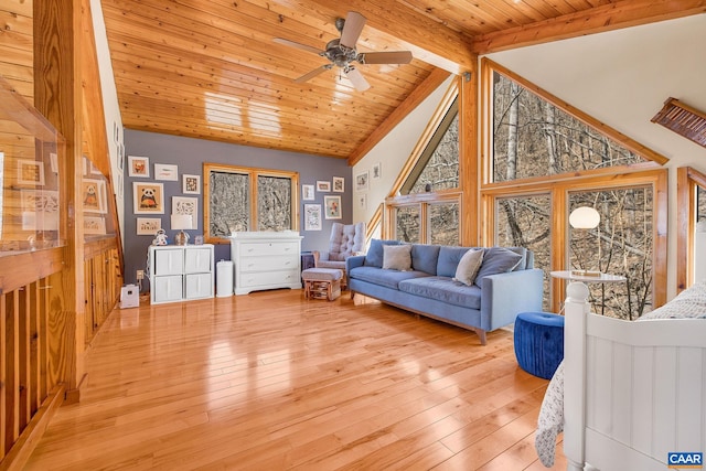 living room featuring wooden ceiling, light wood finished floors, lofted ceiling with beams, and ceiling fan