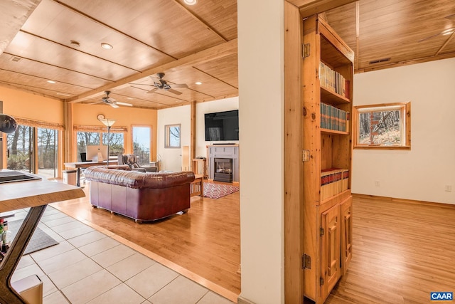 living room with recessed lighting, ceiling fan, wood ceiling, light wood-style floors, and a fireplace