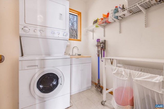 6696 Highlander Way, Crozet, VA 22932 - laundry room featuring stacked washing machine and dryer, cabinet space, light tile patterned flooring, and baseboards