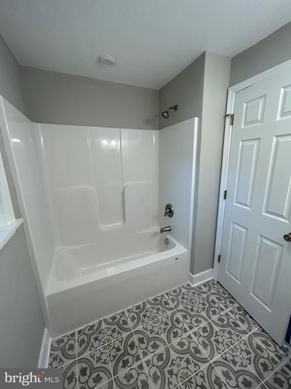 1346 Lakeshore Dr N, Louisa, VA 23093 - full bath with tub / shower combination and tile patterned floors
