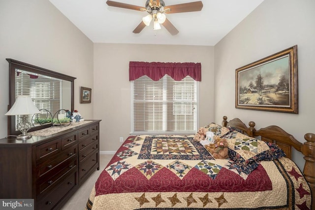 bedroom with light colored carpet, baseboards, and a ceiling fan