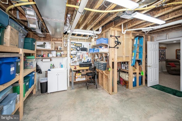 unfinished basement featuring a workshop area