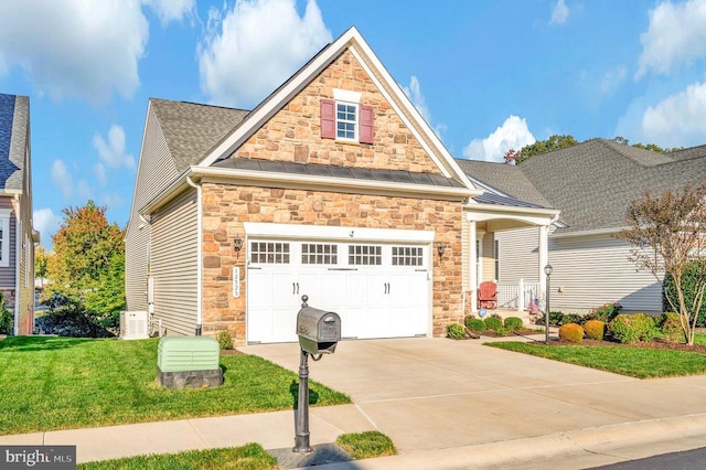 view of front of home featuring stone siding, concrete driveway, a front lawn, and a standing seam roof