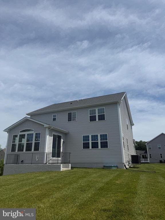 8720 Afton Dr, Spotsylvania, VA 22551 - rear view of property featuring a lawn and central AC
