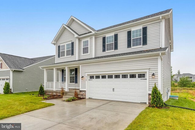 8720 Afton Dr, Spotsylvania, VA 22551 - traditional-style house with a porch, a front yard, concrete driveway, an attached garage, and stone siding