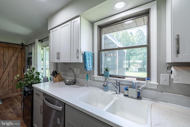 7208 Kirtley Trl, Culpeper, VA 22701 - kitchen featuring dishwasher, light countertops, dark wood-style flooring, white cabinets, and a barn door