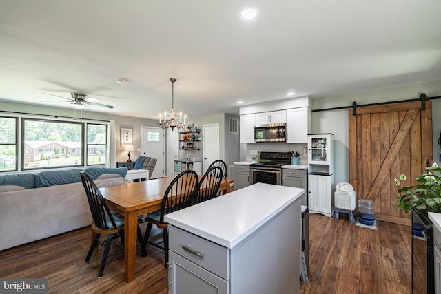 7208 Kirtley Trl, Culpeper, VA 22701 - kitchen with stainless steel appliances, open floor plan, a barn door, dark wood-type flooring, and recessed lighting