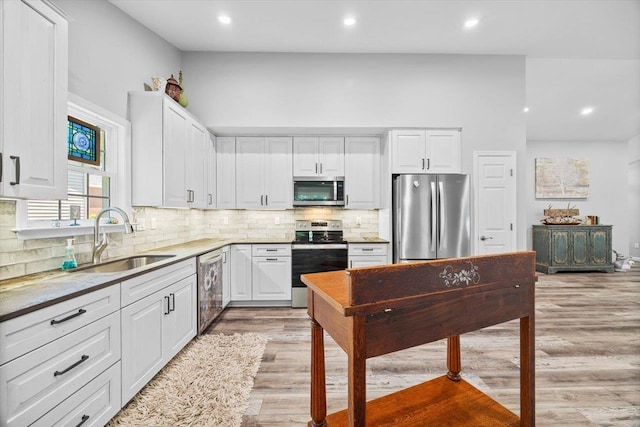 7 Oak View Dr, Staunton, VA 24401 - kitchen with appliances with stainless steel finishes, light wood finished floors, white cabinets, recessed lighting, and backsplash