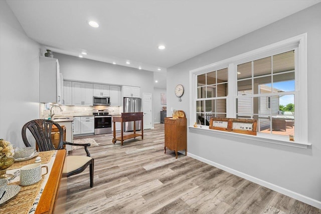 7 Oak View Dr, Staunton, VA 24401 - kitchen featuring appliances with stainless steel finishes, light wood-style floors, white cabinetry, decorative backsplash, and light countertops