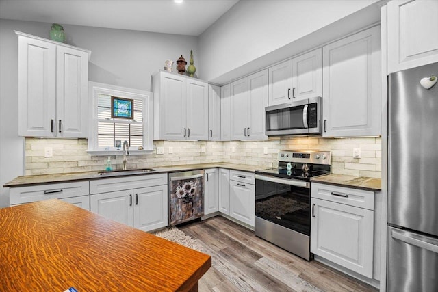 7 Oak View Dr, Staunton, VA 24401 - kitchen featuring appliances with stainless steel finishes, wood finished floors, white cabinets, decorative backsplash, and recessed lighting