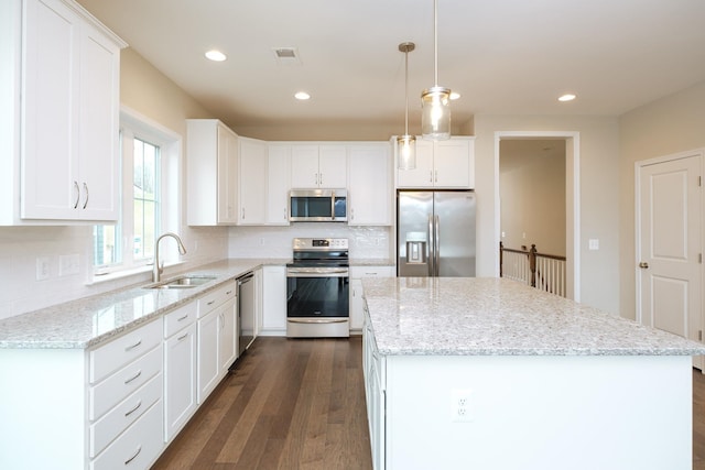 2892 Rutlege Rd Unit 177, Rockingham, VA 22801 - kitchen with a sink, visible vents, a center island, white cabinets, and appliances with stainless steel finishes