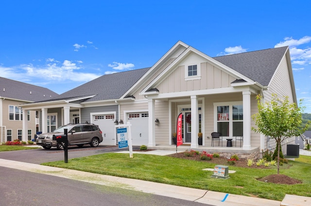 2892 Rutlege Rd Unit 177, Rockingham, VA 22801 - view of front of house with covered porch, driveway, an attached garage, board and batten siding, and a front yard
