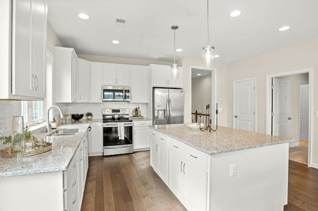 2892 Rutlege Rd Unit 177, Rockingham, VA 22801 - kitchen with appliances with stainless steel finishes, dark wood finished floors, backsplash, white cabinetry, and recessed lighting