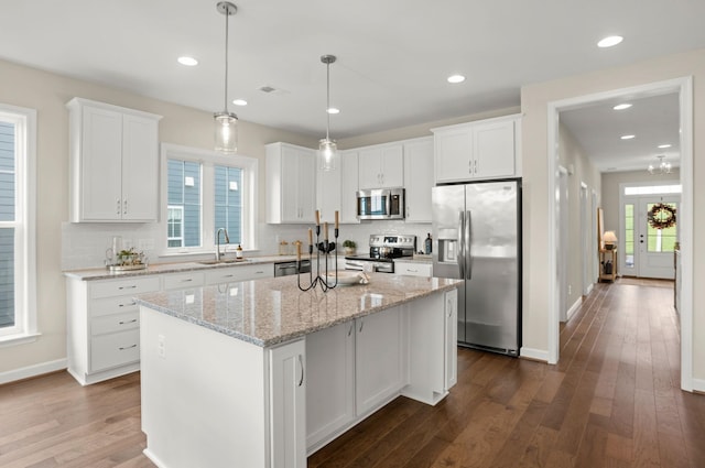 2892 Rutlege Rd Unit 177, Rockingham, VA 22801 - kitchen featuring stainless steel appliances, dark wood finished floors, white cabinetry, a kitchen island, and backsplash