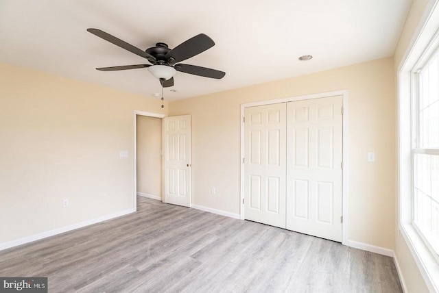 407 Leola Loop, Stanley, VA 22851 - unfurnished bedroom with wood finished floors, a closet, multiple windows, and baseboards