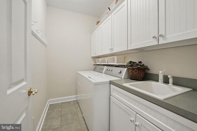 11208 Valor Bridge Dr, Spotsylvania, VA 22551 - washroom featuring a sink, cabinet space, washer and clothes dryer, baseboards, and light tile patterned flooring