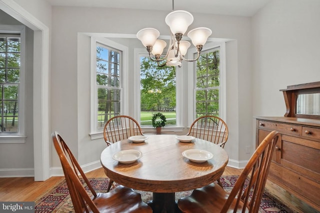 11208 Valor Bridge Dr, Spotsylvania, VA 22551 - dining space with light wood-style flooring, a notable chandelier, and baseboards