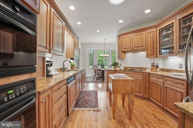 11208 Valor Bridge Dr, Spotsylvania, VA 22551 - kitchen featuring a sink, light wood-type flooring, black appliances, recessed lighting, and light stone countertops