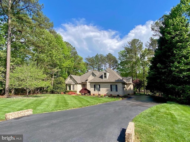 11208 Valor Bridge Dr, Spotsylvania, VA 22551 - new england style home featuring aphalt driveway, brick siding, and a front yard