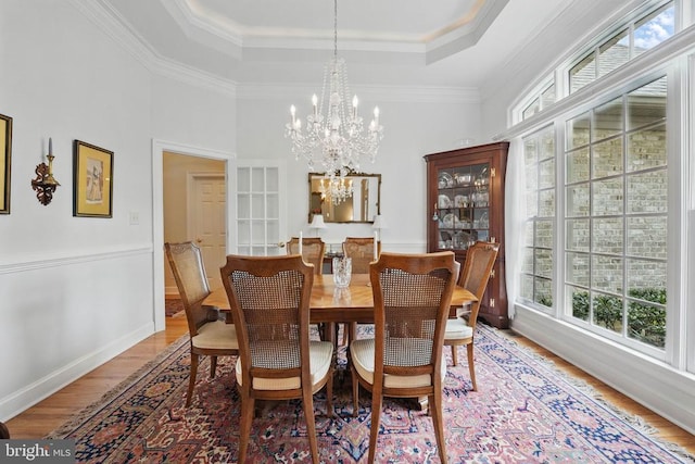 11208 Valor Bridge Dr, Spotsylvania, VA 22551 - dining area with an inviting chandelier, a raised ceiling, ornamental molding, and wood finished floors