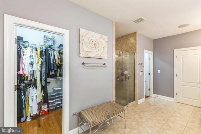 32314 Deep Meadow Ln, Locust Grove, VA 22508 - full bathroom with a shower stall, a walk in closet, and baseboards